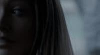 a close up of a woman's face with a blurry background