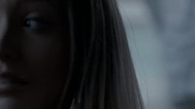 a close up of a woman's face with a blurry background