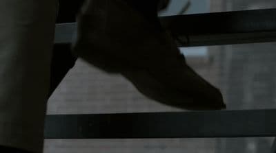 a close up of a person's foot on a railing