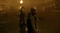 a couple of people that are standing in the dark