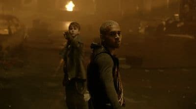 a couple of people that are standing in the dark