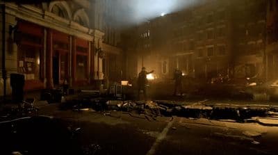 a dark city street at night with a fire hydrant