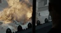 a man looking out a window at a large fire