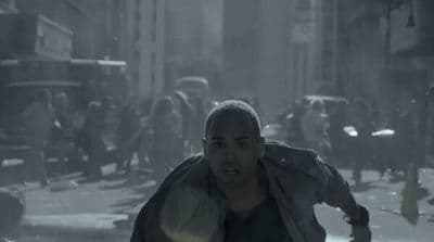 a man running through a city street in the rain