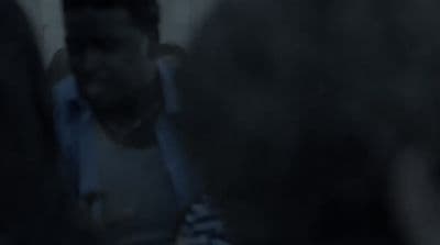 a blurry photo of a man in a white shirt