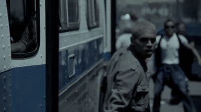 a man walking next to a bus on a street