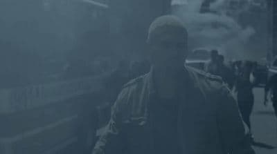 a man walking down a street in the fog