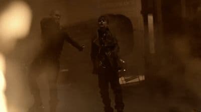 a couple of people that are standing in the dark