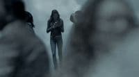 a woman standing in front of a group of people
