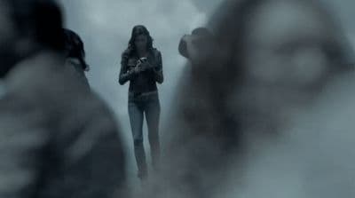 a woman standing in front of a group of people