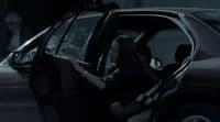 a woman sitting in the driver's seat of a car