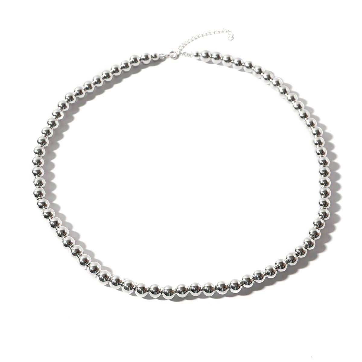 a silver beaded necklace on a white background