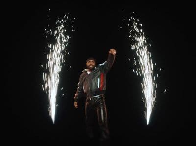 a man standing in front of two fireworks