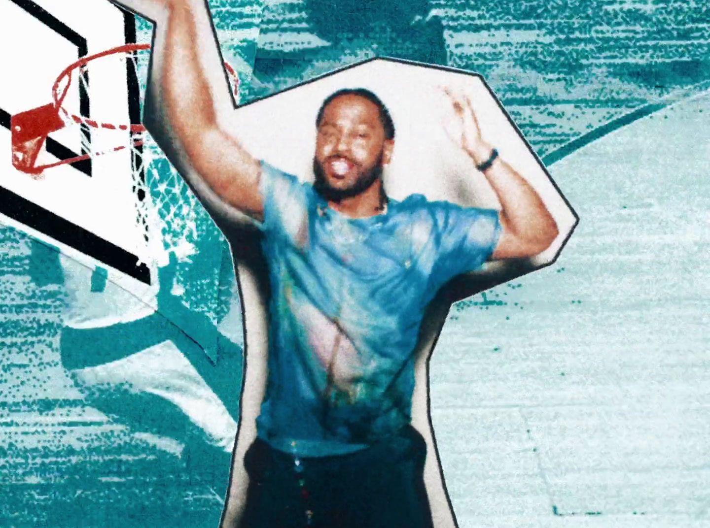 a man holding a basketball in front of a basketball hoop
