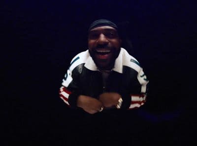a man in a black and white jacket laughing