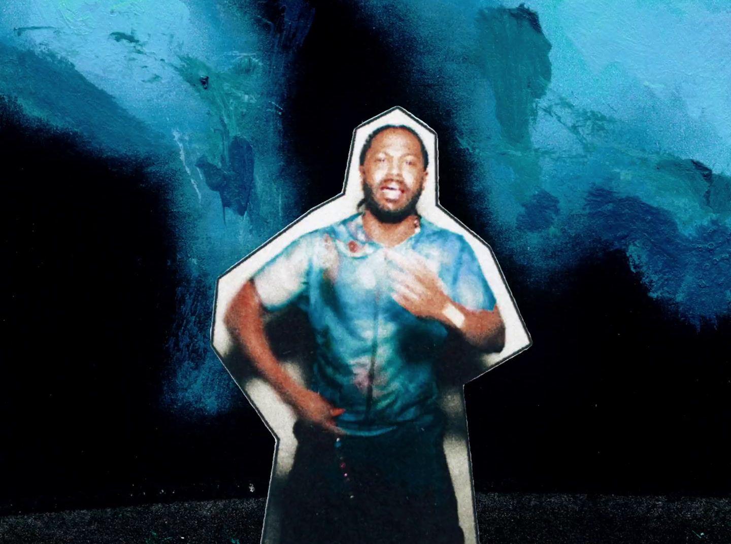 a picture of a man standing in front of a blue background