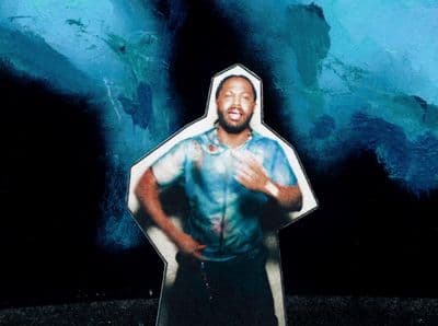 a picture of a man standing in front of a blue background