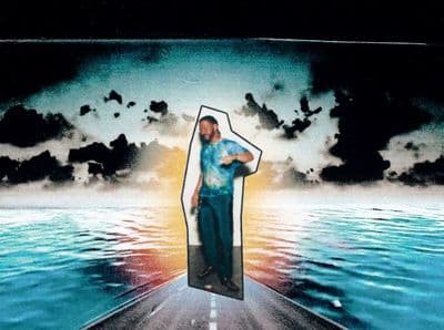 a man standing on a boat in the middle of a body of water