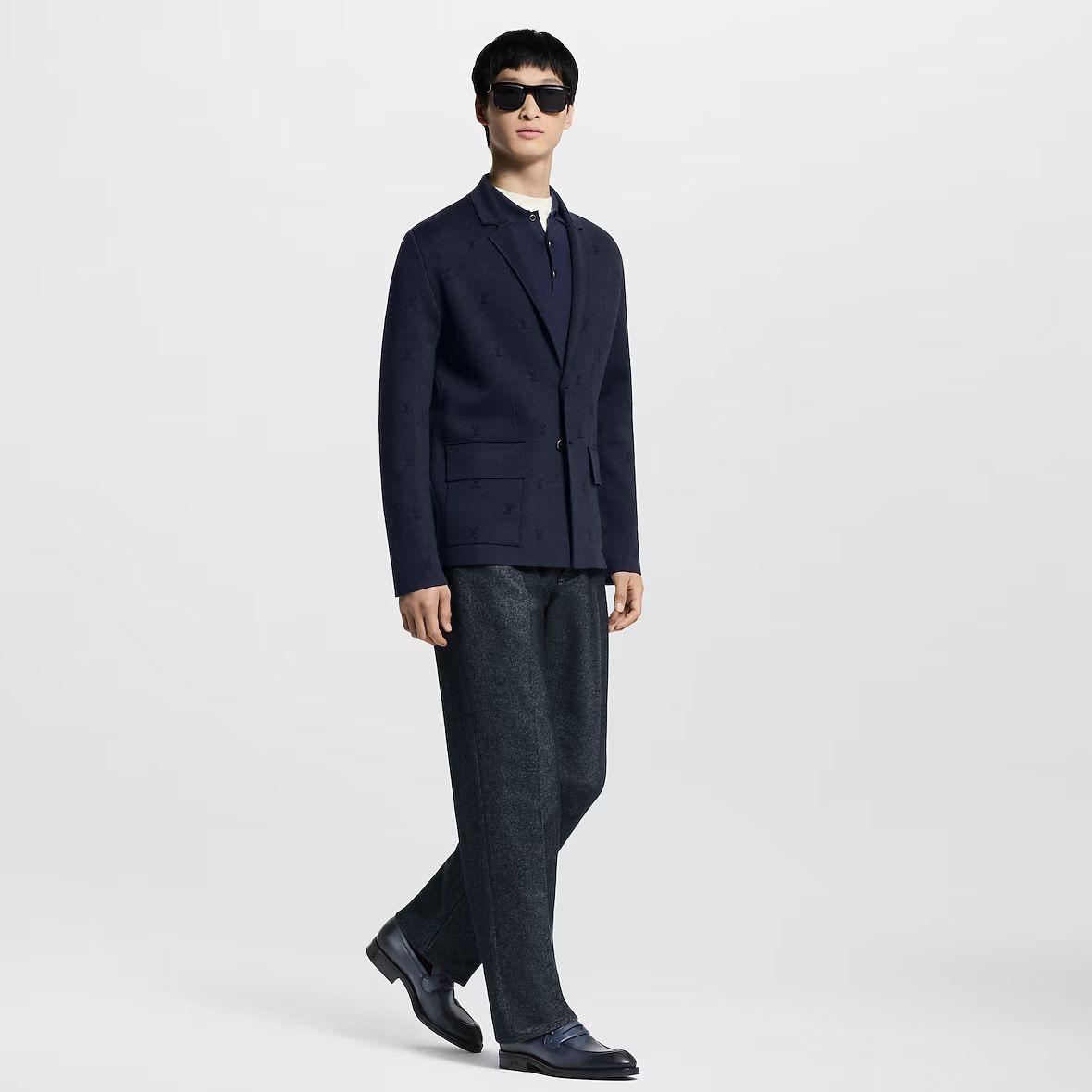 a man in a suit and sunglasses is standing