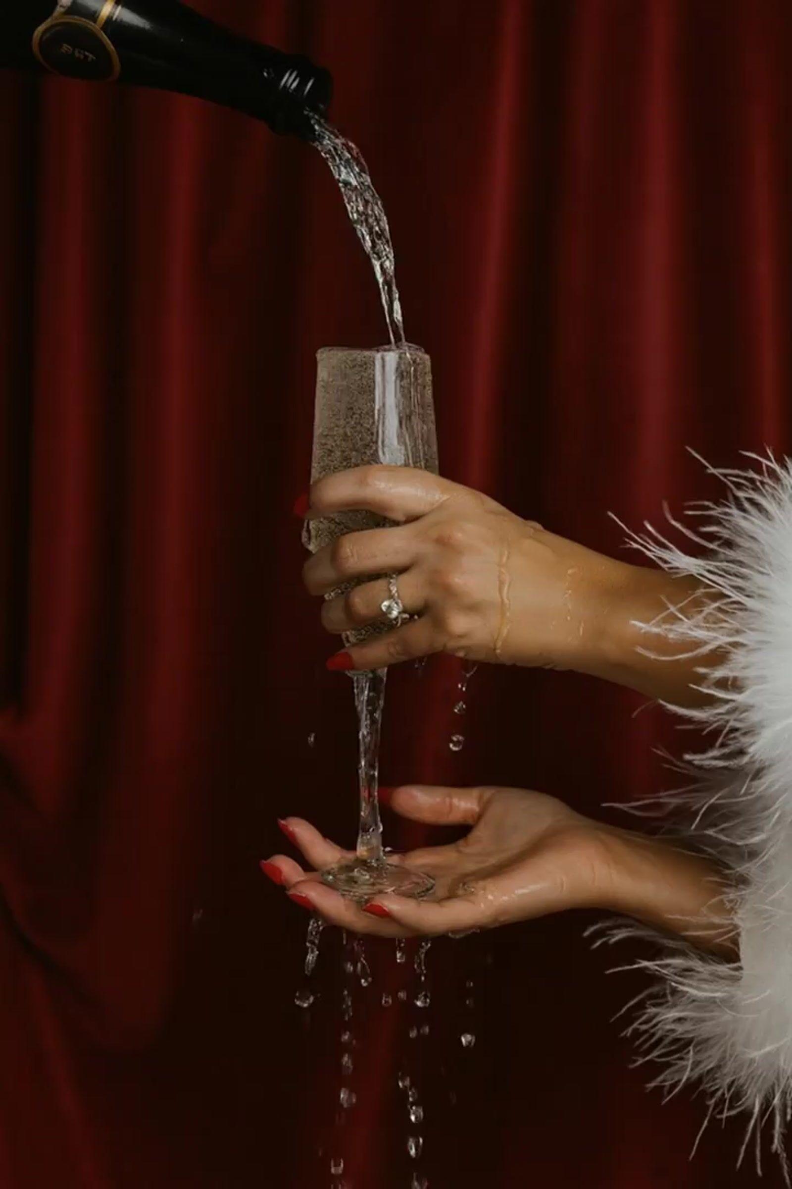a woman pouring a glass of wine into a wine glass