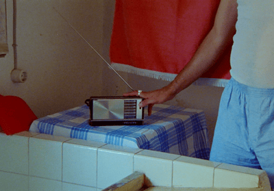 a man is holding a radio in his hand