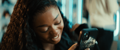 a woman is looking at her cell phone