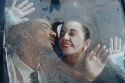 a man and a woman are kissing in a car
