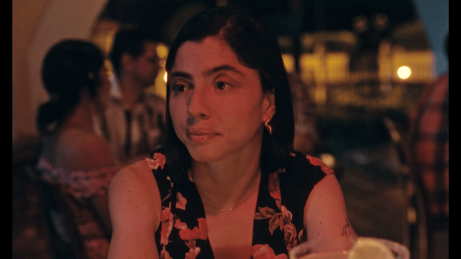 a woman sitting at a table in a restaurant