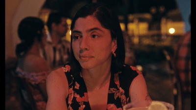 a woman sitting at a table in a restaurant