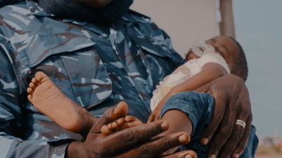 a man holding a baby in his arms