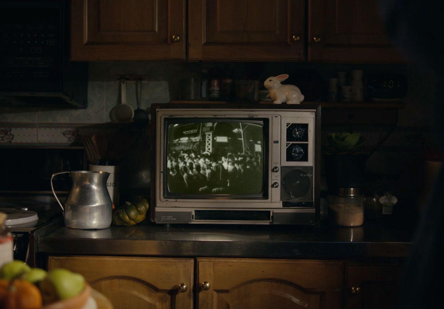 a small television sitting on top of a kitchen counter