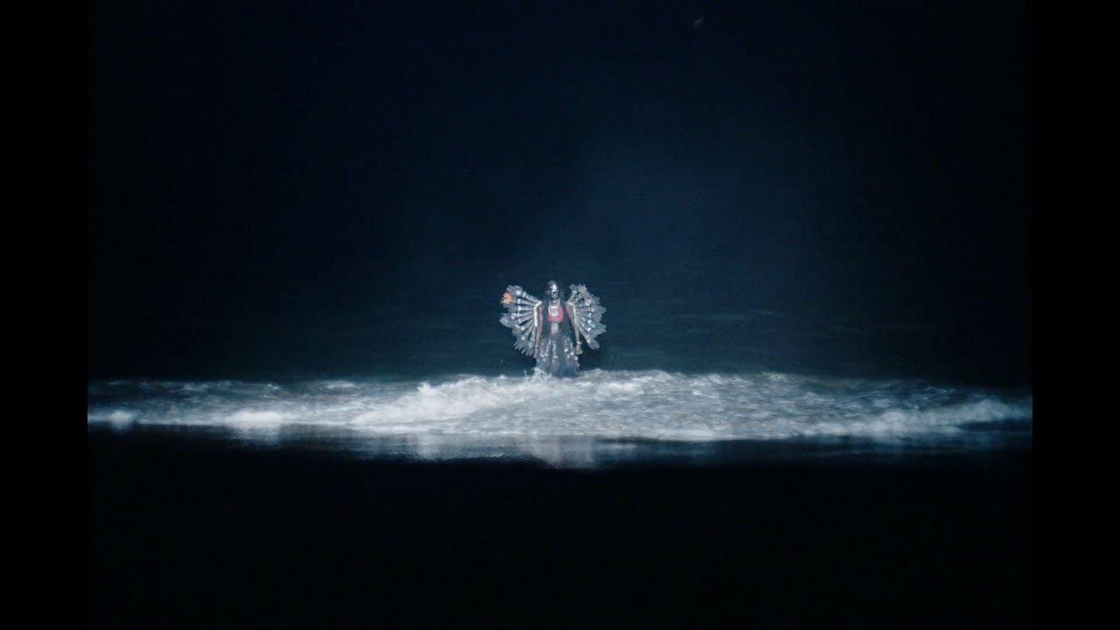 a person riding a wave in the ocean at night