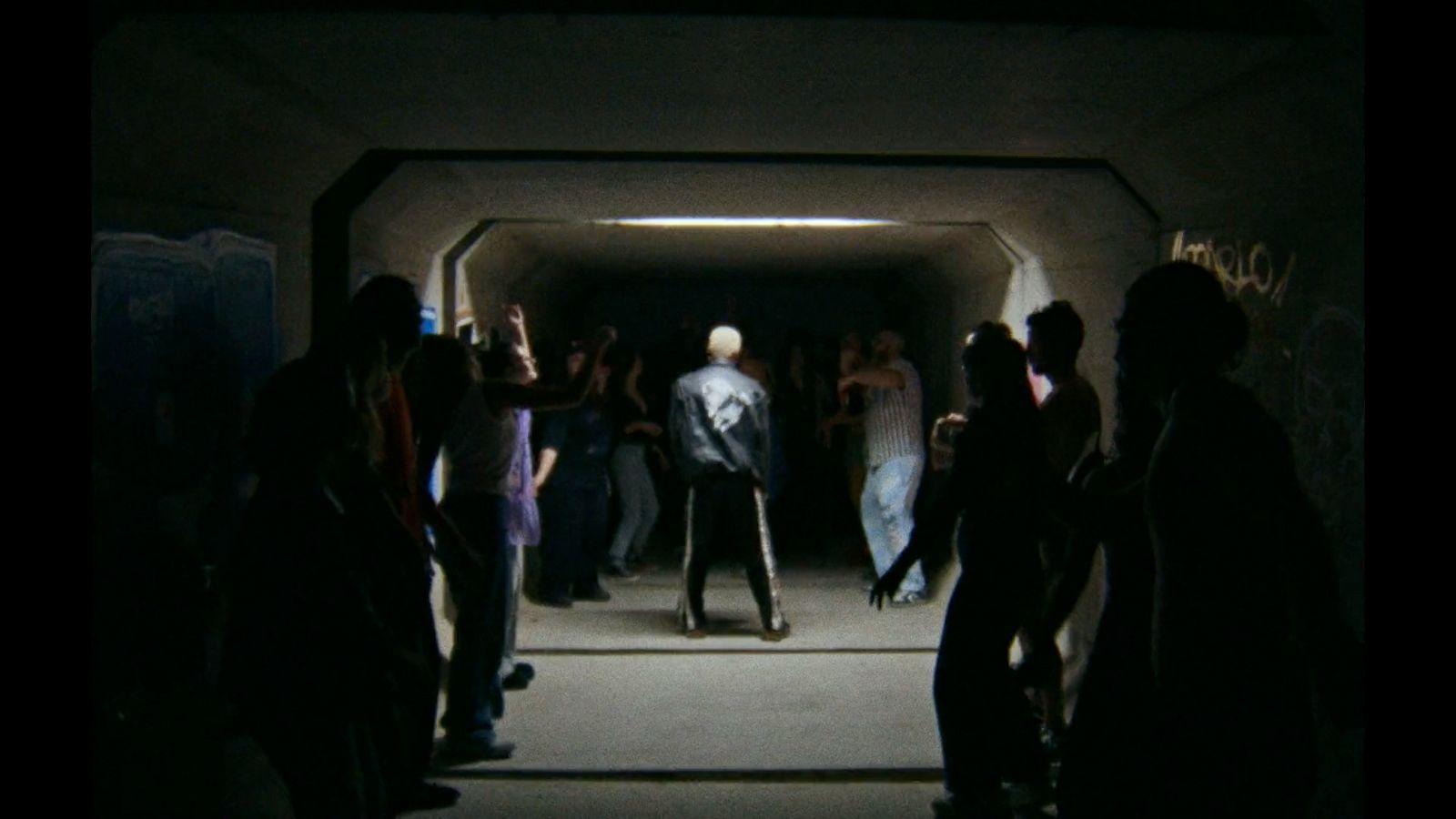 a group of people standing in a tunnel