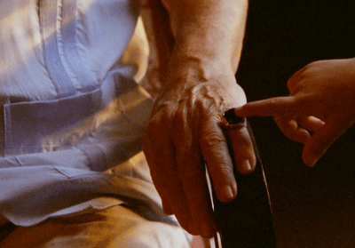 a person holding a cigarette in their hand