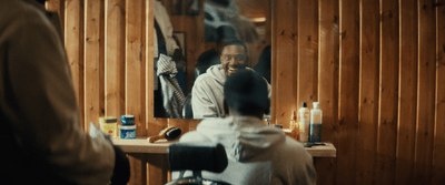 a man sitting in a chair in front of a mirror