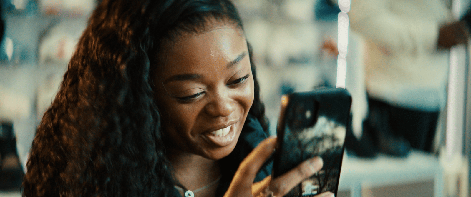 a woman is looking at her cell phone