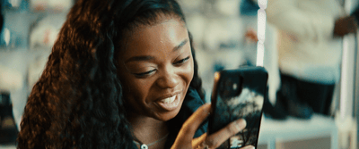 a woman is looking at her cell phone