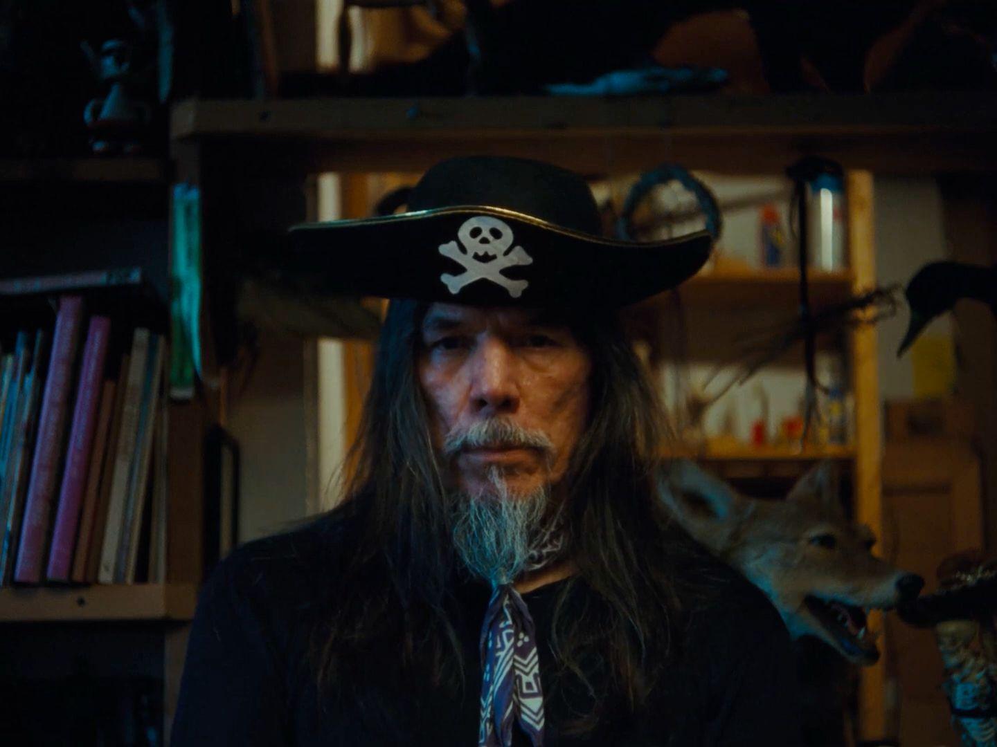 a man wearing a pirate hat and a tie