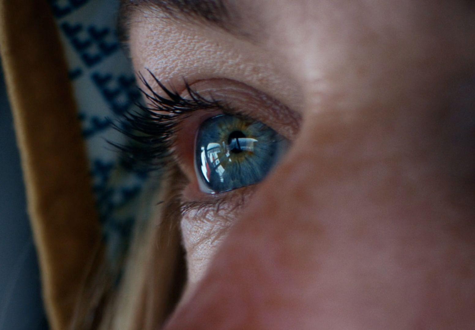 a close up of a woman's blue eye