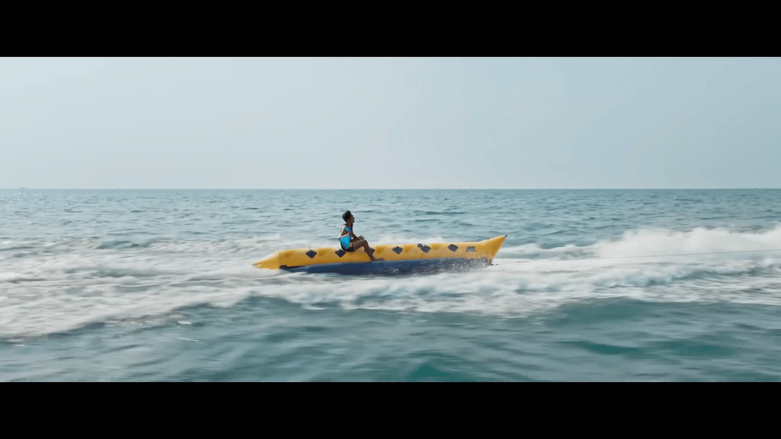 a person on a yellow boat in the ocean