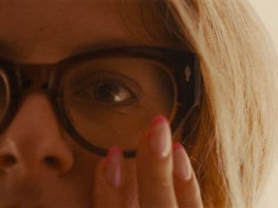 a close up of a person wearing glasses