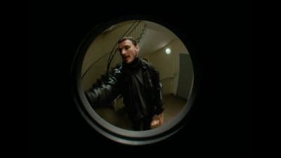 a man in a black leather jacket is taking a selfie