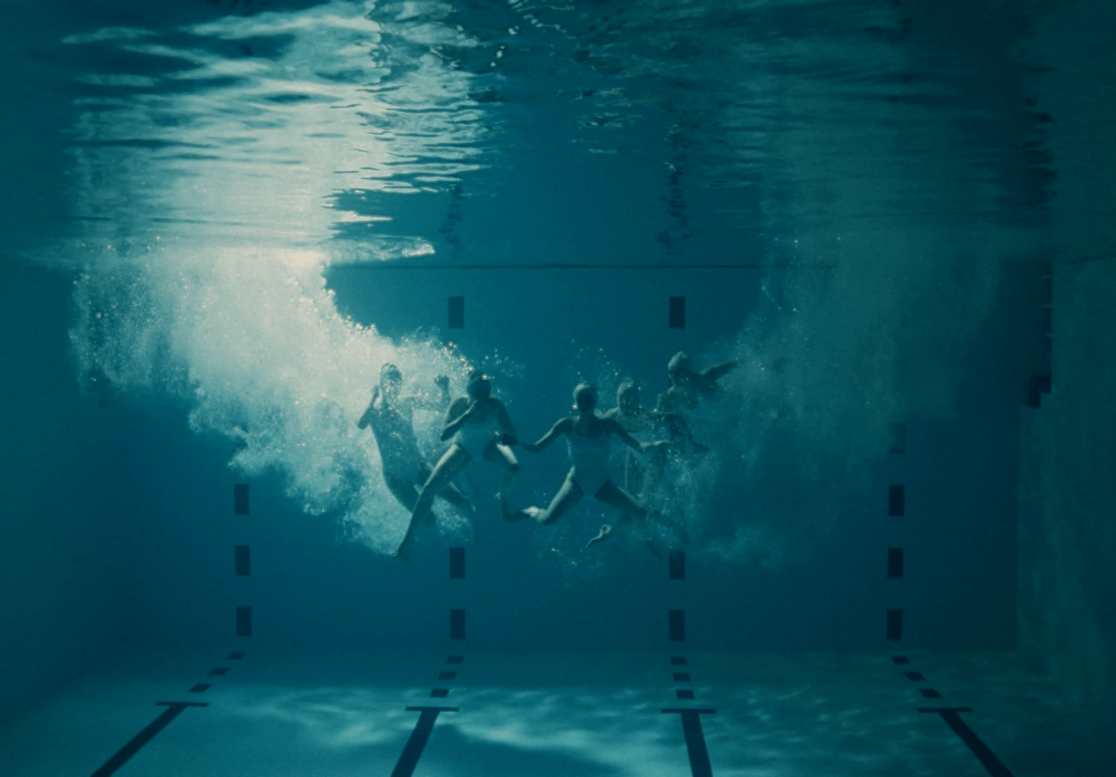 a group of people swimming in a pool