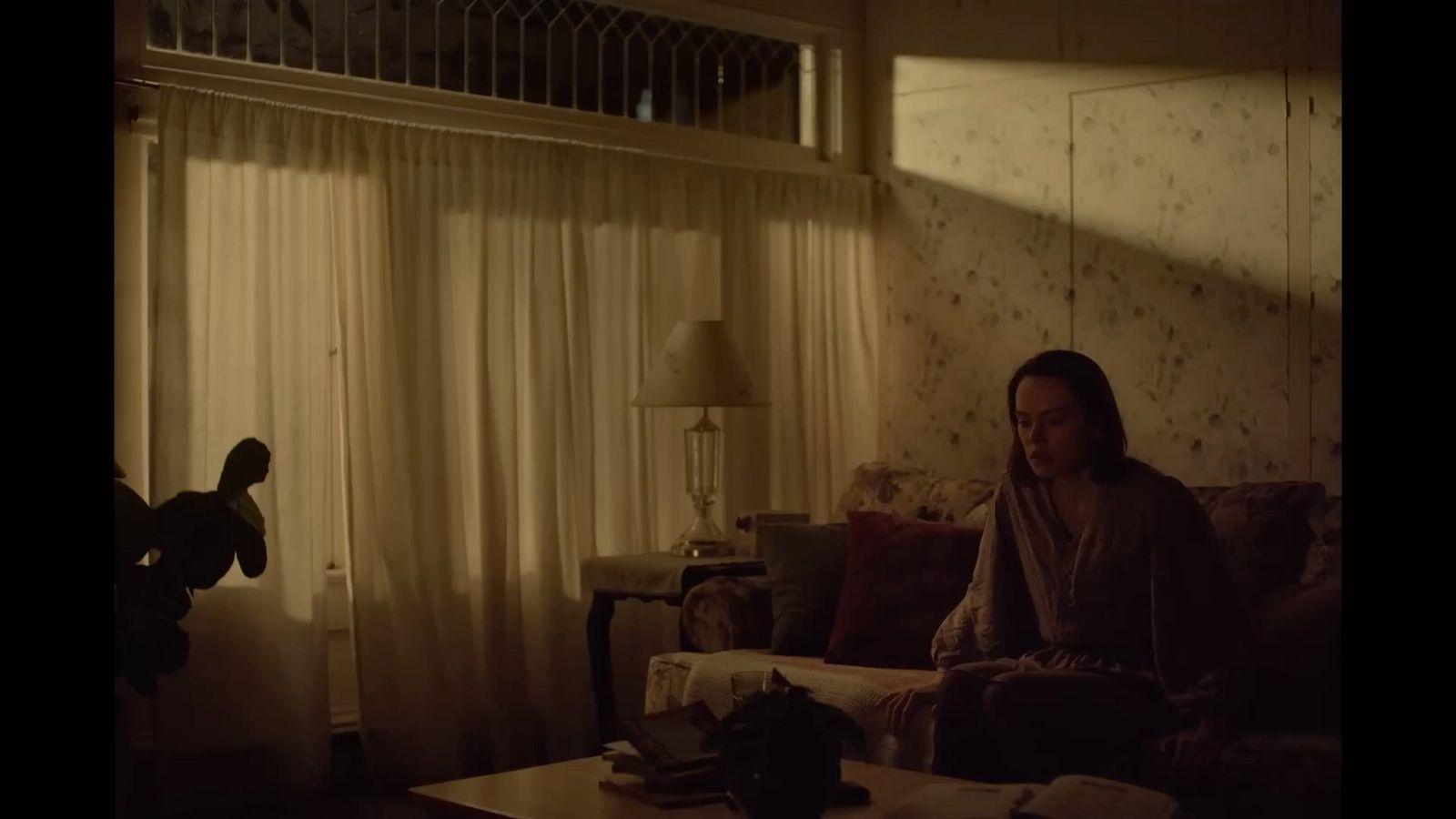 a woman sitting on a couch in a living room