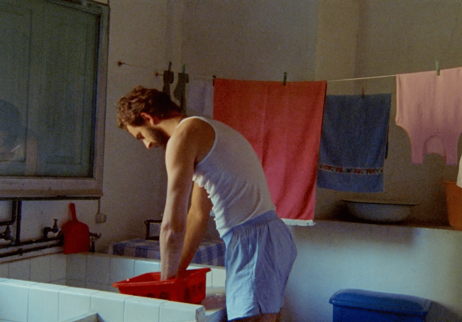a man is washing his hands in the sink