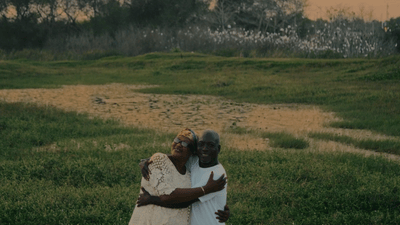 a couple of people that are standing in the grass