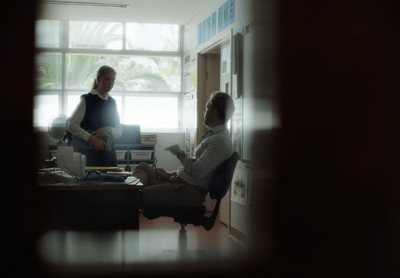 two people sitting at a desk in an office