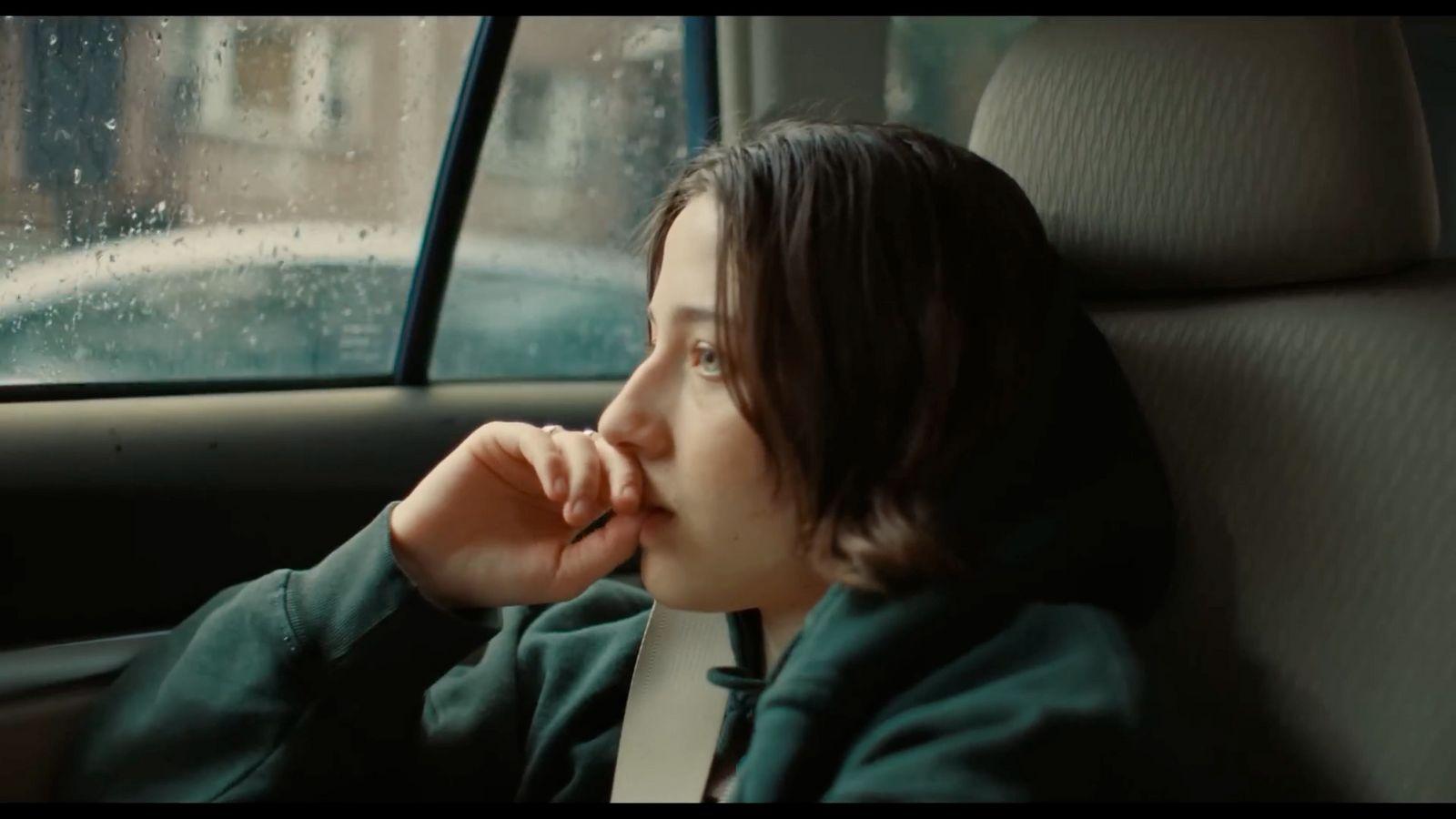 a woman sitting in the back seat of a car