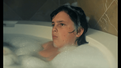 a woman in a bathtub with bubbles of water
