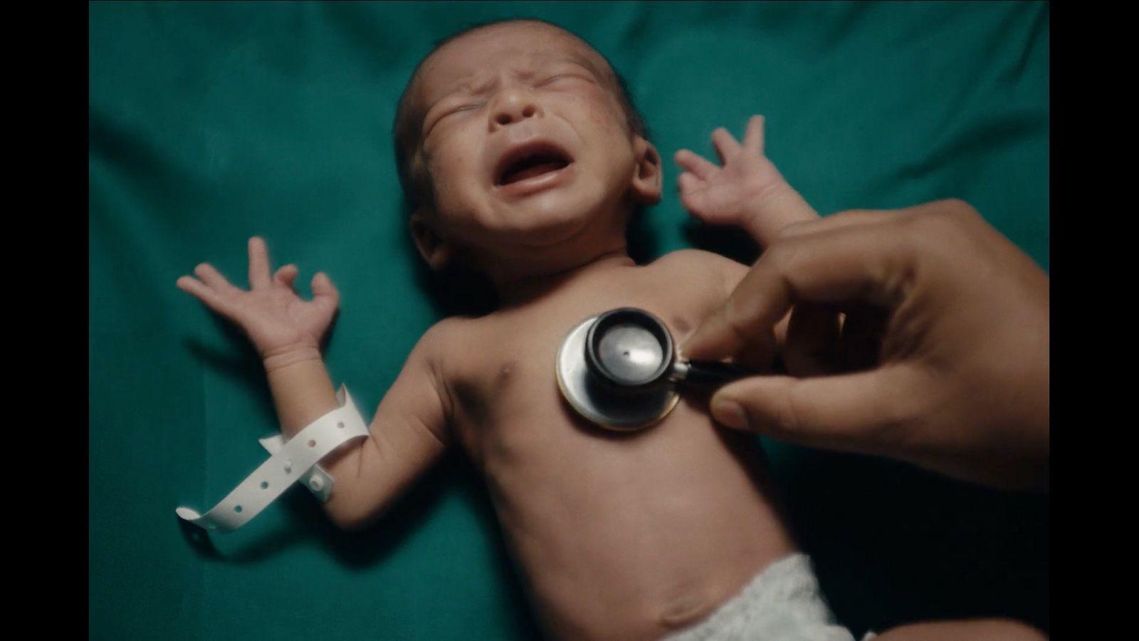 a baby being examined by a doctor with a stethoscope